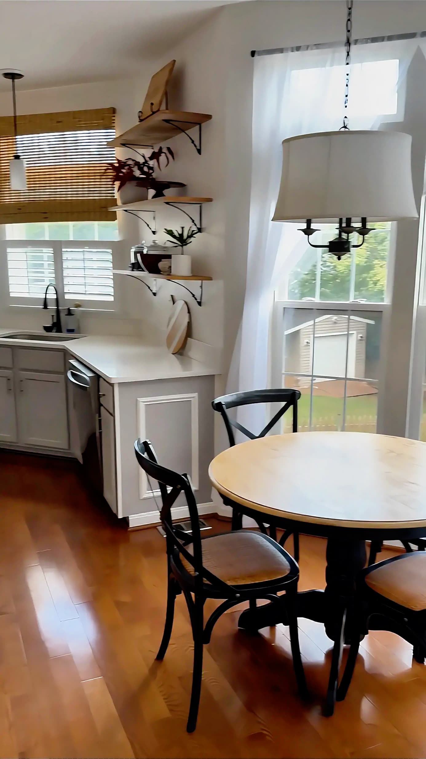 Freshly cleaned dining area beside a bright kitchen
