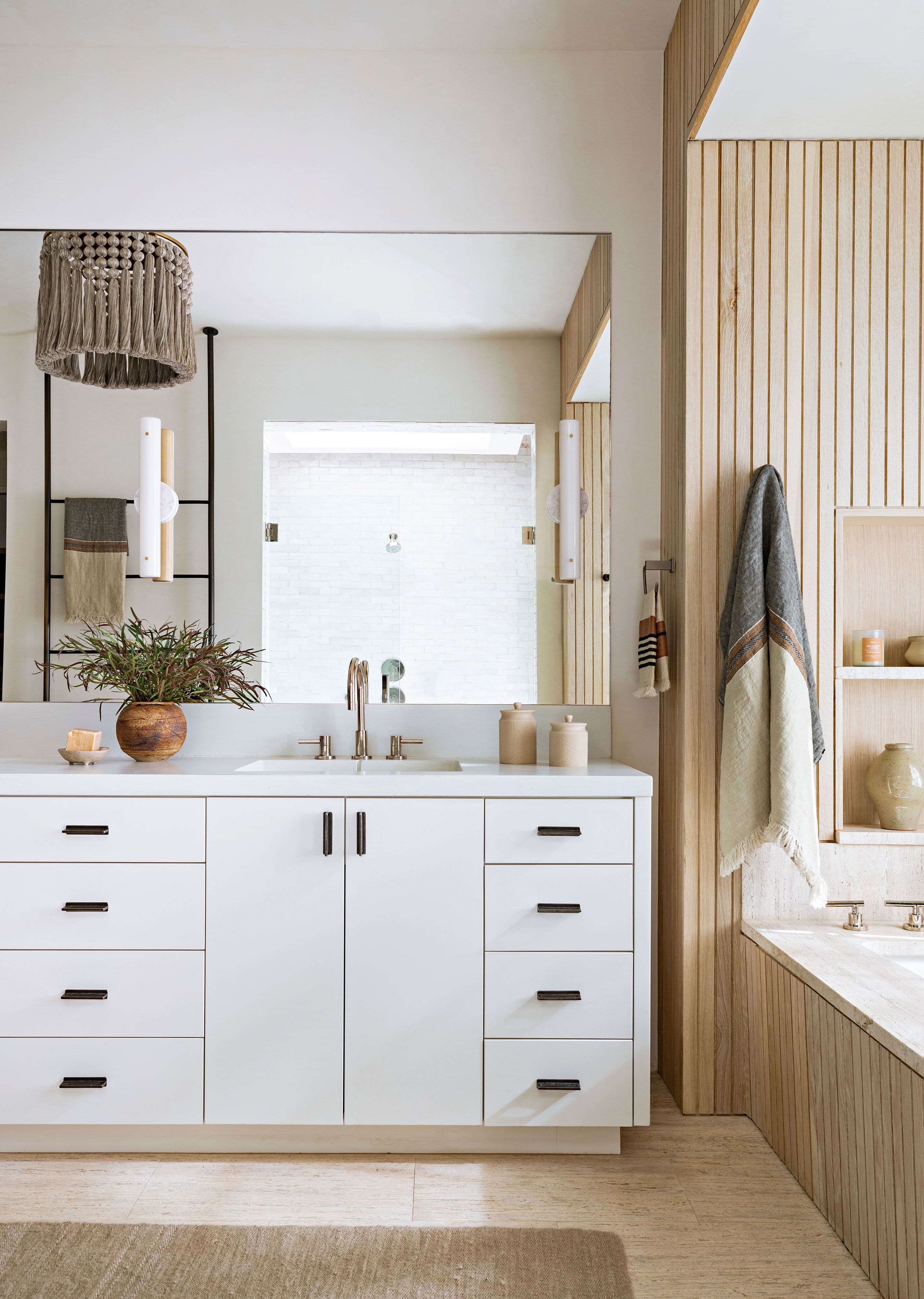 Bright, carefully styled bathroom vanity and shower
